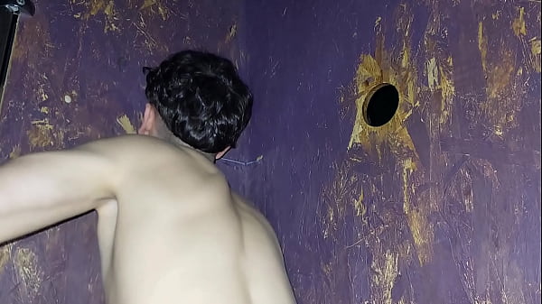 Young twink guy sucks a hard male dick at glory hole while public cruising